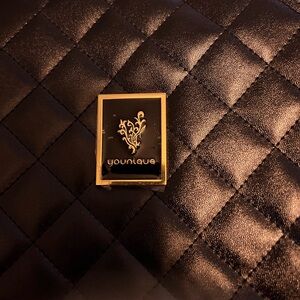 Younique Black and Gold Emblem Pin